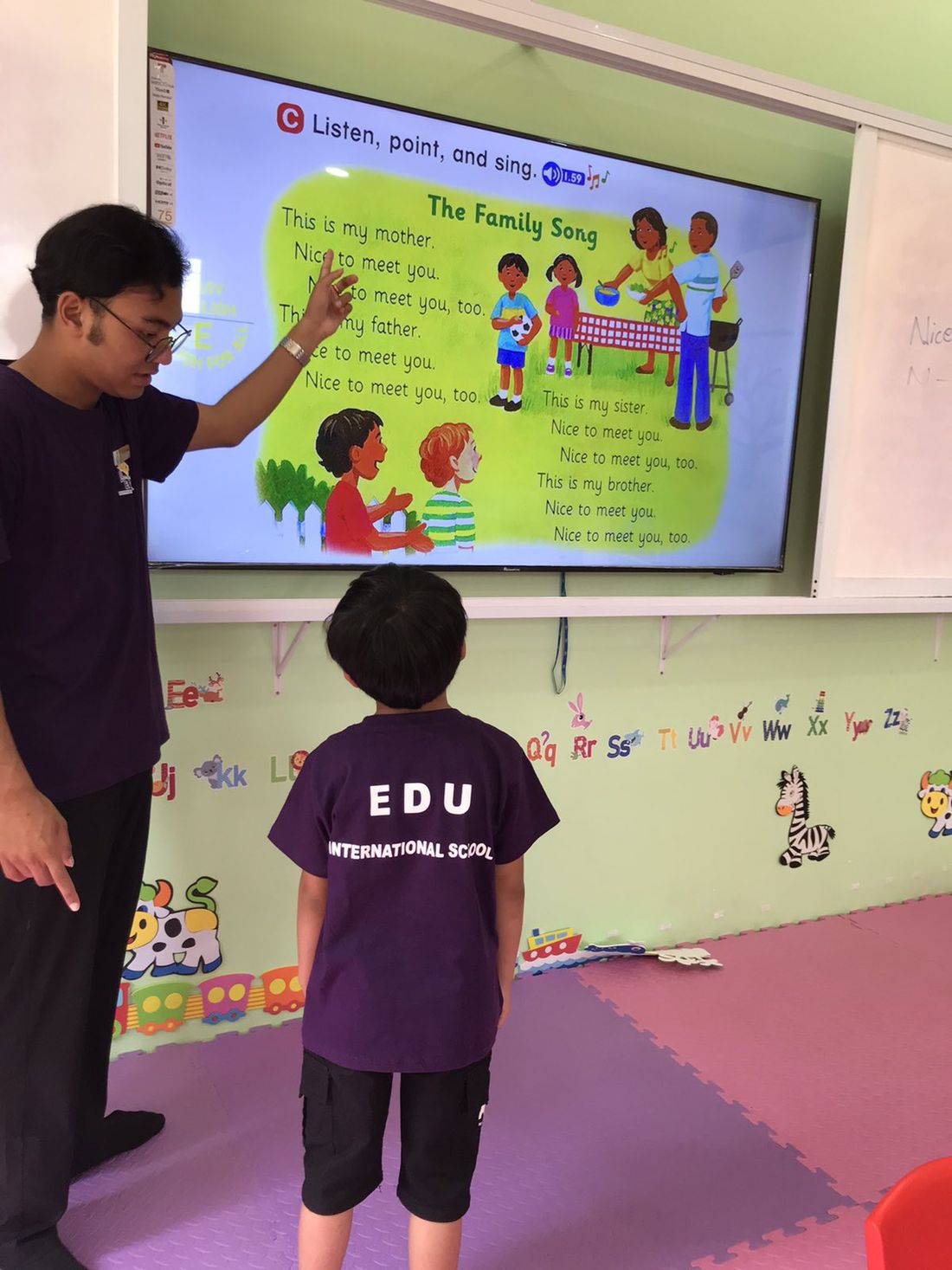 A teacher leading an English lesson at the whiteboard